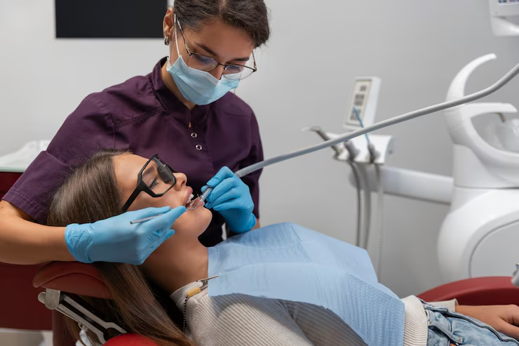 Close up on dentist using instruments Close up on dentist using instruments<br />